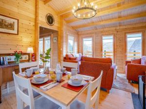a dining room with a table and a couch at Dôl Werdd Lodge in Glanamman +8 photos