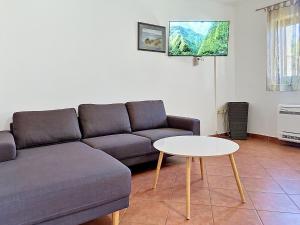 a living room with a couch and a table at Holiday Home Gorana by Interhome in Mirce