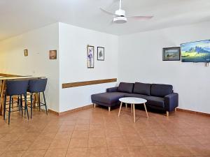 a living room with a couch and a table at Holiday Home Gorana by Interhome in Mirce