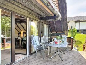 a patio with a table and chairs on a deck at Holiday Home Ferienpark Vorauf-4 by Interhome in Molberting