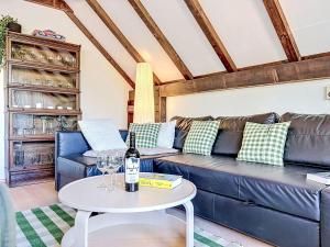 a living room with a blue couch and a table at Holiday Home Ferienpark Vorauf-4 by Interhome in Molberting