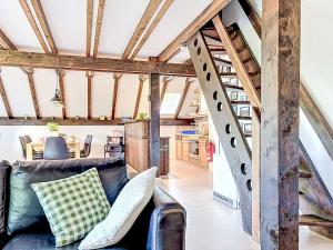 a living room with a couch and a staircase at Holiday Home Ferienpark Vorauf-4 by Interhome in Molberting