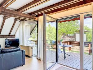 a living room with sliding glass doors leading to a patio at Holiday Home Ferienpark Vorauf-4 by Interhome in Molberting +28 photos