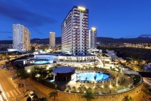 a large building with two pools in a city at night at Paraiso Pool and Sea Views by Olax Rentals in Playa Paraiso