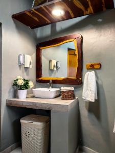 a bathroom with a sink and a mirror at Munati B&B in Musina +21 photos