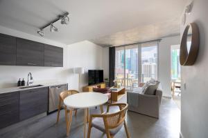 a kitchen and living room with a table and chairs at Stylish Pool Stay Near Brickell & Beach in Miami