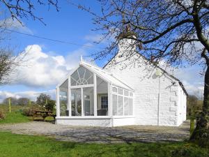 a white building with a large window at Horsepark Cottage in Girthon +14 photos