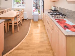 a kitchen with a wooden floor and a counter top at Stanley's Sanctuary in Boot