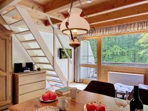 a dining room with a table and a staircase at Apartment Fliederweg by Interhome in Siegsdorf +17 photos