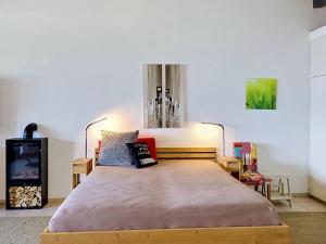a bedroom with a large bed in a room at Apartment Residenza Miralago Apt- C27 by Interhome in Piazzogna