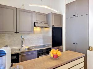 a kitchen with a bowl of fruit on a counter at Apartment Residenza Miralago Apt- C27 by Interhome in Piazzogna