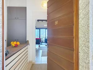 a hallway with a door leading to a kitchen at Apartment Residenza Miralago Apt- C27 by Interhome in Piazzogna