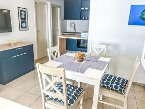 a kitchen with a white table with chairs and a sink at Apartment Renata by Interhome in Barić Draga