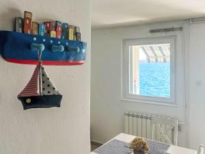 a room with a window and a boat on the wall at Apartment Renata by Interhome in Barić Draga