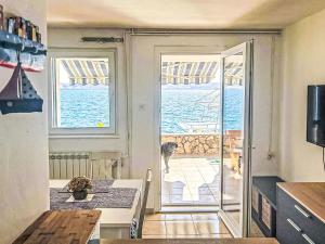 a kitchen with a table and a view of the ocean at Apartment Renata by Interhome in Barić Draga