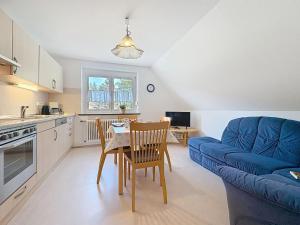 a kitchen and living room with a table and a blue couch at Apartment Fischer by Interhome in Eisenbach +24 photos