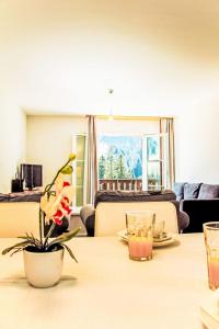 a living room with a table with a flower on it at Apartment Andromède 3-pièces A34 by Interhome in Moleson