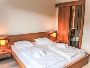 a bedroom with a large bed with two white pillows at Apartment Andromède 3-pièces A34 by Interhome in Moleson