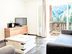 a living room with a couch and a tv at Apartment Andromède 3-pièces A34 by Interhome in Moleson +19 photos