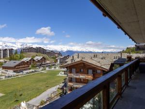 a view from the balcony of a resort with snow covered mountains at Apartment Le Refuge 1 by Interhome in Nendaz