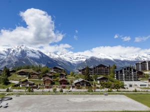 a view of a resort with mountains in the background at Apartment Le Refuge 1 by Interhome in Nendaz