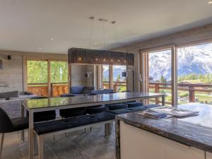 a dining room with a table and chairs and mountains at Apartment Le Refuge 1 by Interhome in Nendaz