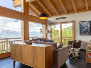 a living room with a couch and chairs and windows at Chalet D'Arby by Interhome in Nendaz +34 photos