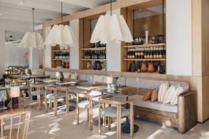 a restaurant with tables and chairs and chandeliers at Rickety Bridge Estate in Franschhoek +52 photos
