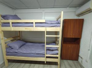 two bunk beds in a small room with a cabinet at Ліза in Irpin