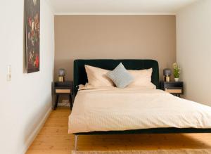 a bed with a green headboard in a bedroom at Travetraum in Lübeck