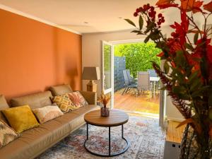 a living room with a couch and a table at Travetraum in Lübeck