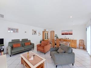 a living room with two couches and a table at Villa Ladine by Interhome in Le Barcarès