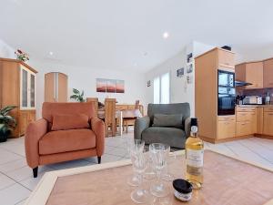 a bottle of wine sitting on a table in a living room at Villa Ladine by Interhome in Le Barcarès +60 photos