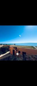 a building with a view of the ocean at Bungalow sul mare in Costa Rei +5 photos