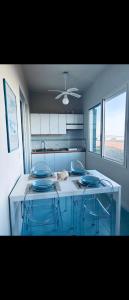 a kitchen with a table with blue plates on it at Bungalow sul mare in Costa Rei