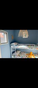 a small bedroom with two bunk beds and a window at Bungalow sul mare in Costa Rei