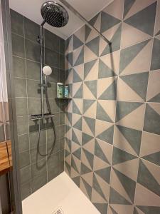 a bathroom with a shower with black and white tiles at Vue incroyable Loire et Chateau in Amboise +38 photos