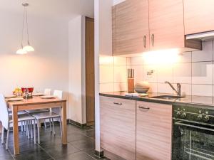 a kitchen and dining room with a table and chairs at Apartment Andromède 6 by Interhome in Moleson