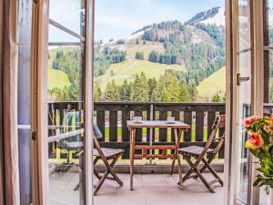 a balcony with a table and chairs and a mountain view at Apartment Andromède 6 by Interhome in Moleson