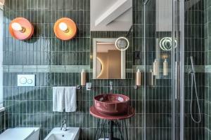 a bathroom with a sink and a tub at Barberini 16- Boutique Hotel in Rome