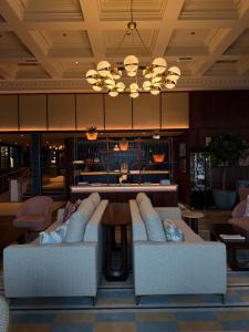 a lobby with two couches and a chandelier at Mount Errigal Hotel, Conference & Leisure Centre in Letterkenny