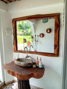 a bathroom with a stone sink and a mirror at 1920 Casa Campestre in Córdoba