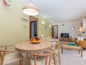 a kitchen and living room with a table and chairs at Holiday Home Florencia by Interhome in Pals