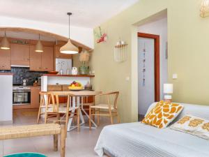 a bedroom with a bed and a kitchen with a table at Holiday Home Florencia by Interhome in Pals