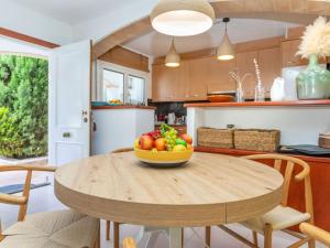 a bowl of fruit on a wooden table in a kitchen at Holiday Home Florencia by Interhome in Pals +30 photos