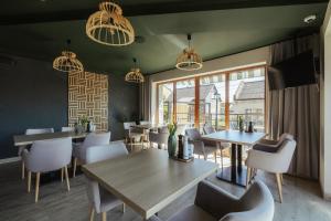 a dining room with a table and chairs at Przystań Leśniów in Żarki