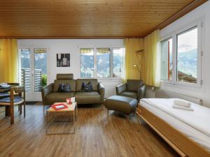 a bedroom with a bed and a living room at Apartment Chalet Albi-2 by Interhome in Grindelwald