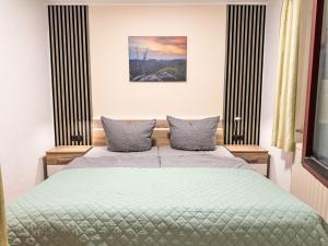 a bedroom with a bed with two pillows at Apartment Apartment Wuff by Interhome in Altendorf