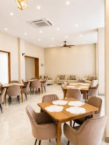 a dining room with tables and chairs and a waiting room at Magnolia Suites B&B in Dar es Salaam