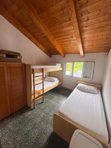a small bedroom with a bunk bed and a ladder at Parco vacanze e appartamenti Pfirsich in Borghetto Santo Spirito